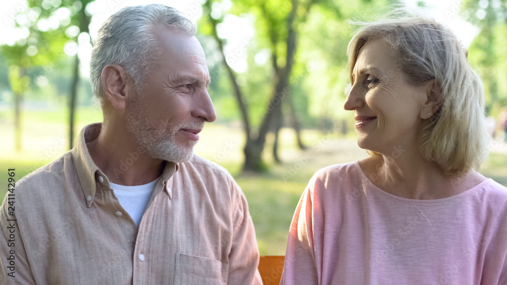 Smiling man and woman looking each other, romantic relations, date happiness Smiling man and woman looking each other, romantic relations, date happiness