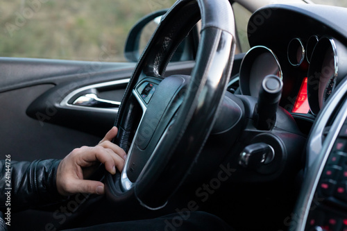 Male driver holding steering wheel while driving © ozencdeniz