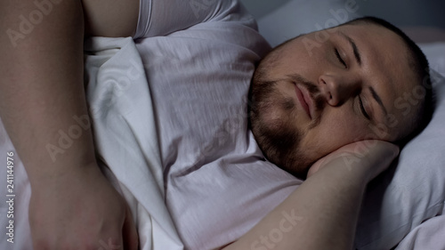 Closeup of chubby man sleeping peacefully, relaxing on comfortable mattress