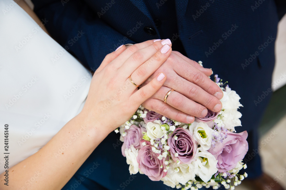 Bride and groom hands with gold wedding rings Bride and groom hands with gold wedding rings