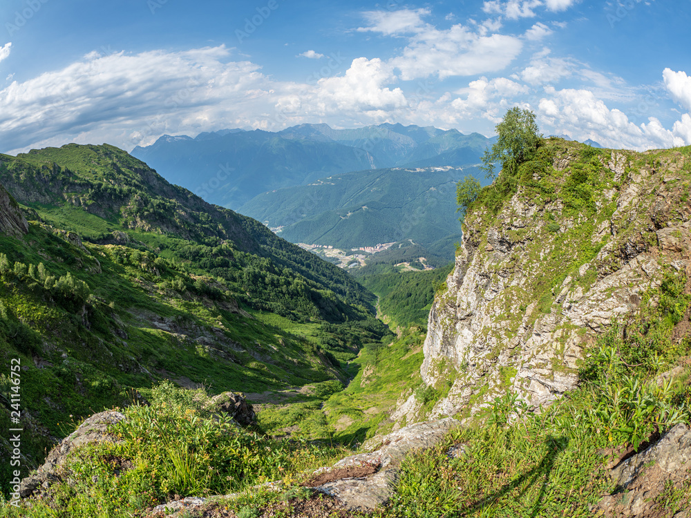 View from the top of the aibga Ridge at the Rosa Khutor ski resort, surrounded by high mountains.
