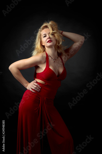 Attractive middle age woman in red evening dress.