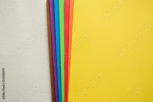 Colorful eva foam sorted on white wooden background
