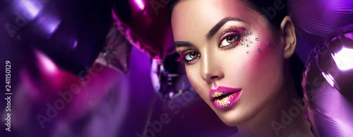 Obraz Beauty fashion model girl creative art makeup with gems. Woman face over purple, pink and violet air balloons background
