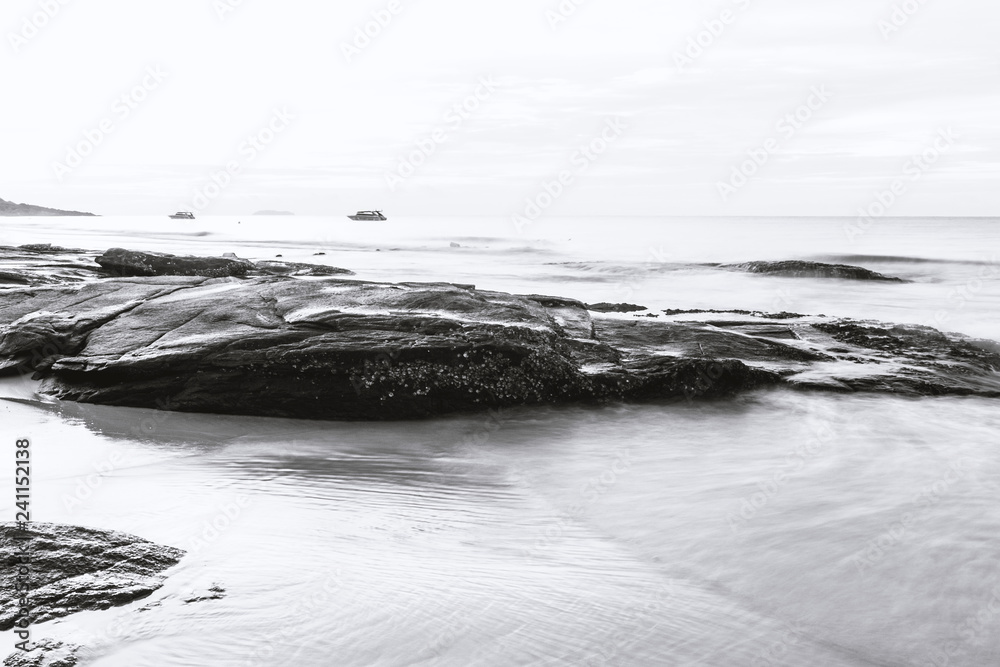 black and white 'sea and rocks around the beach.