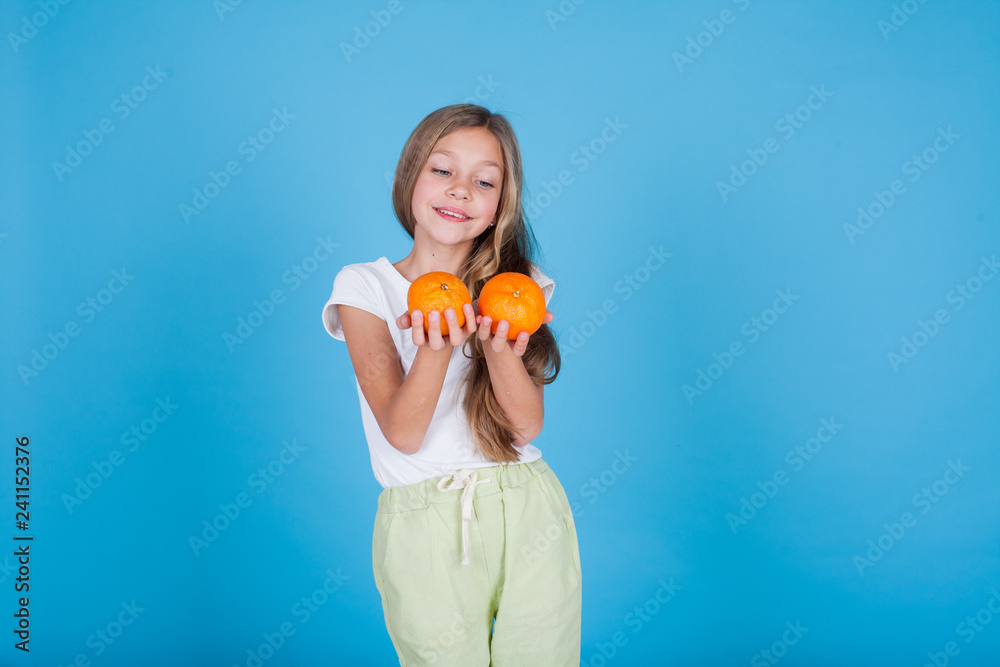 small beautiful girl holding a ripe oranges healthy food small beautiful girl holding a ripe oranges healthy food