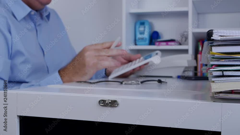 Businessperson with a Pencil in Hand Make Calculations Using Adding Machine Businessperson with a Pencil in Hand Make Calculations Using Adding Machine