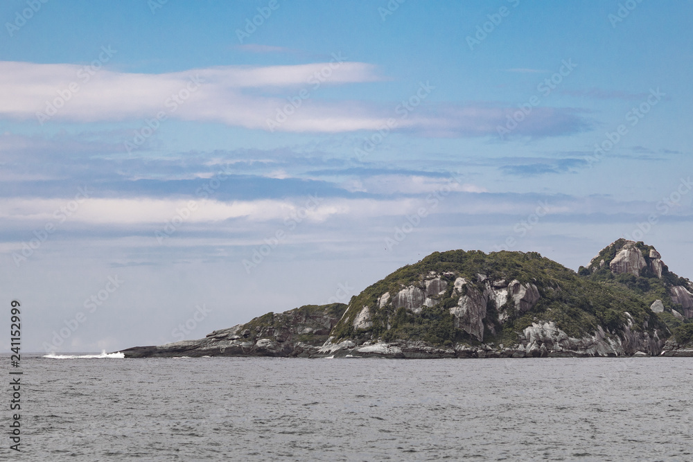 Picturesque uninhabited tropical island just outside of the coast of the city of Rio de Janeiro Picturesque uninhabited tropical island just outside of the coast of the city of Rio de Janeiro