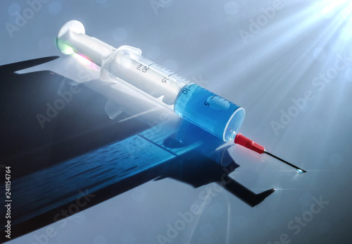 Syringe with medication illuminated laterally, conceptual image