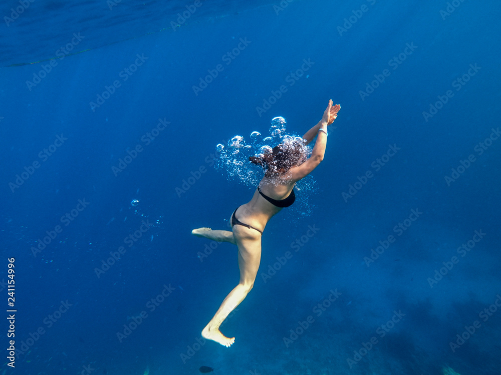 red sea people swim under water