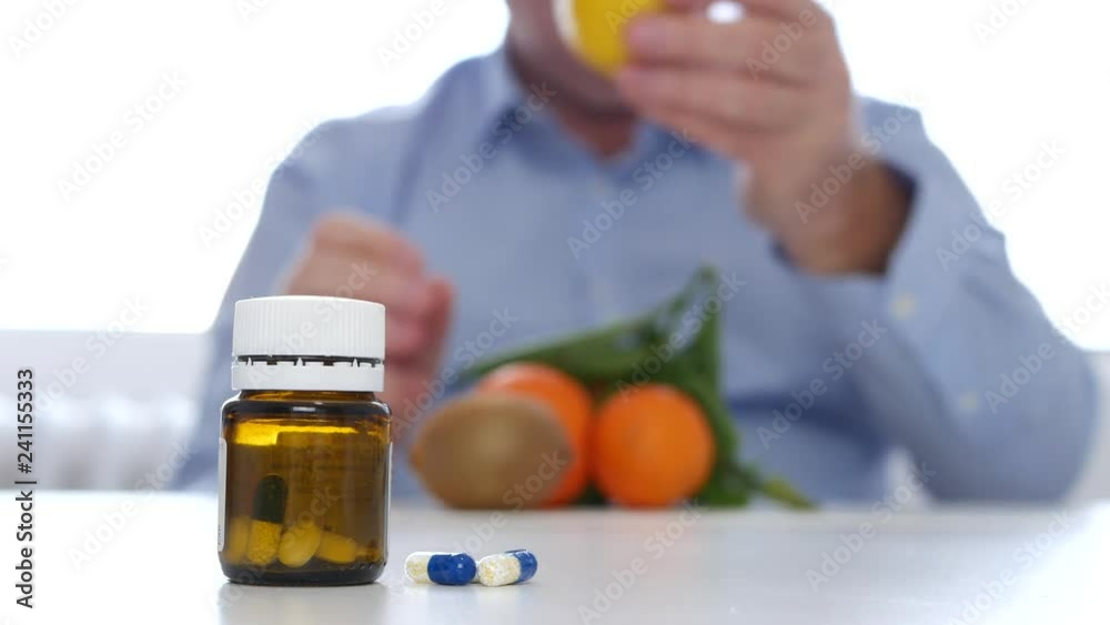 Man Examine Fresh Fruits Like Alternative to Vitamins Cure with Medicine Pills Man Examine Fresh Fruits Like Alternative to Vitamins Cure with Medicine Pills