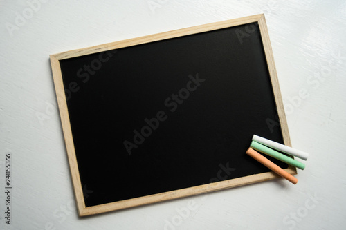 View from top on the blackboard with three chalk