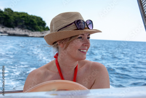 Women in mid 40's driving a small boat.