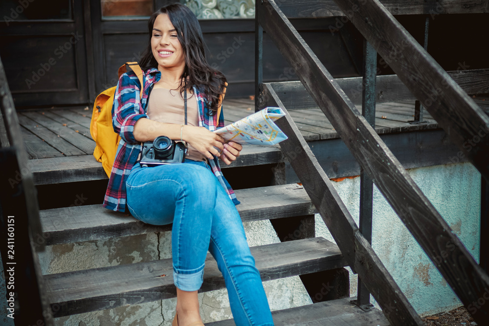 Young woman sits on the stairs of a forest house Young woman sits on the stairs of a forest house