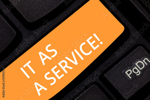 Writing note showing It As A Service. Business photo showcasing Information technology giving services to business Keyboard key Intention to create computer message pressing keypad idea photo