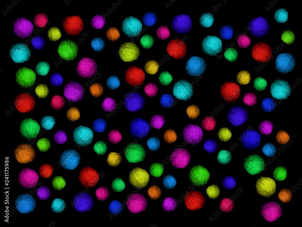 Multi-colored skeins of wool on a black background. Multicolored balls. Colored wool in the balls. Multi-colored skeins of wool on a black background. Multicolored balls. Colored wool in the balls.