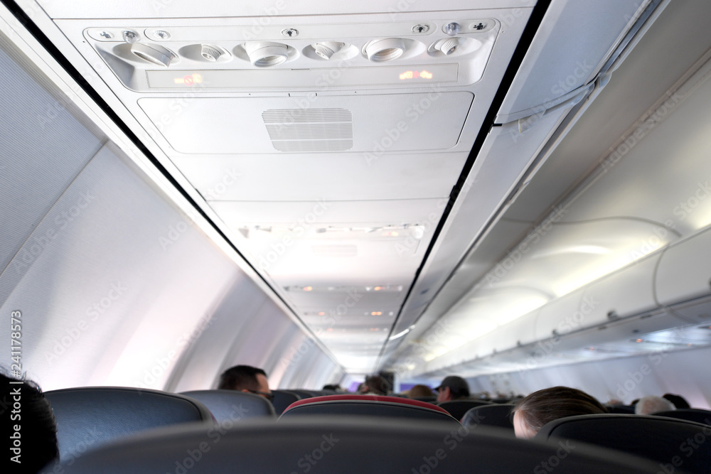 Fototapeta premium Interior view of the seats and ceiling of a commercial airplane.
