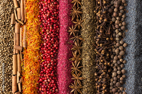 Fototapeta Naklejka Na Ścianę i Meble -  Spices and herbs background. Different seasonings are scattered in stripes color.