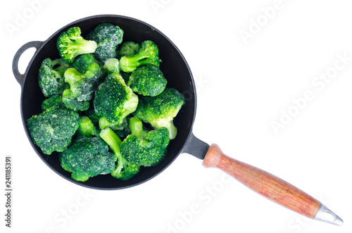 Cast iron pan with frozen broccoli for cooking