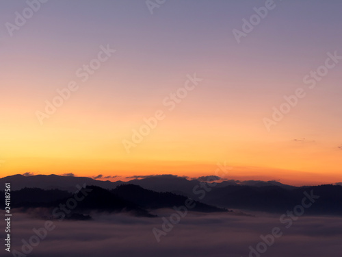 Mountain and foggy at morning time with orange sky  beautiful landscape in the thailand