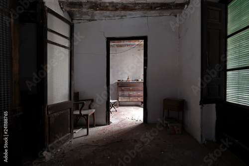 Furniture in the gloom of an abandoned house
