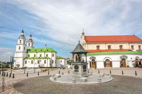 Minsk, Belarus, June 28th 2018 - A boulevard with a orthodox church and a historical building in a blue sky day in Belarus