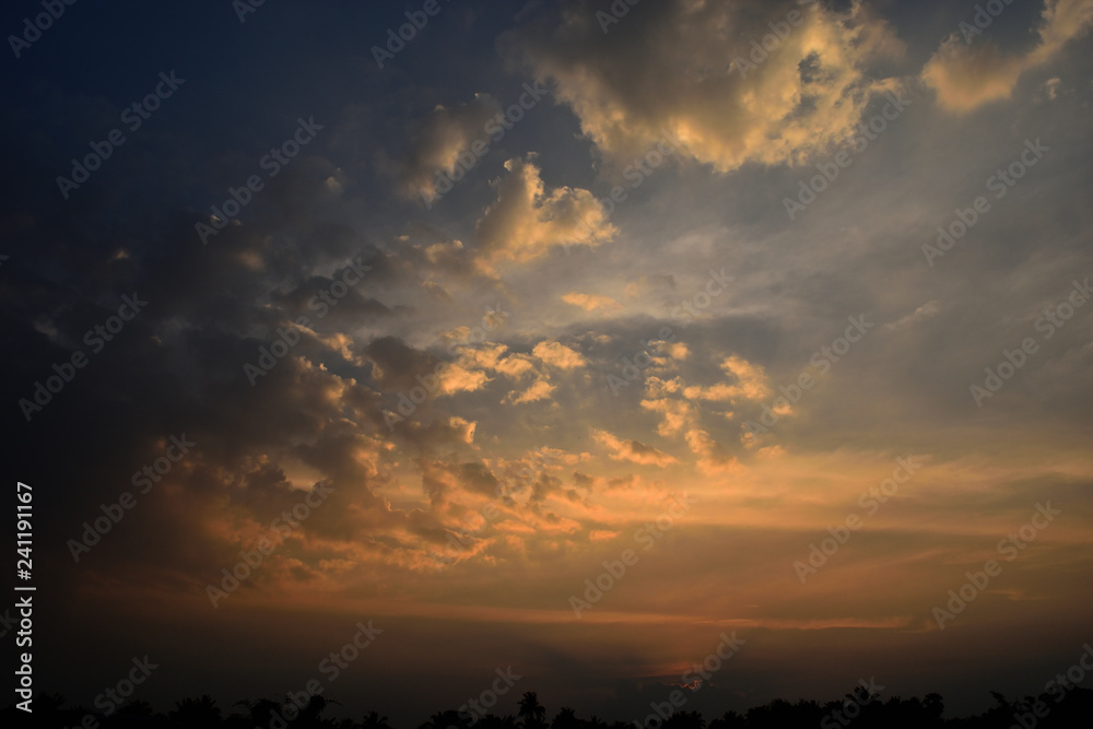 Cumulus cloud on beautiful blue sky at sunset , The horizon becomes orange and gold color , Fluffy clouds formations at tropical zone , Thailand