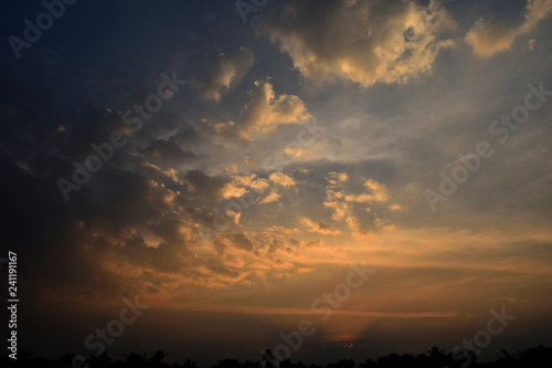 Cumulus cloud on beautiful blue sky at sunset , The horizon becomes orange and gold color , Fluffy clouds formations at tropical zone , Thailand