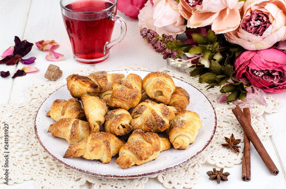 Homemade mini croissants with sugar and cinnamon, wooden background Homemade mini croissants with sugar and cinnamon, wooden background