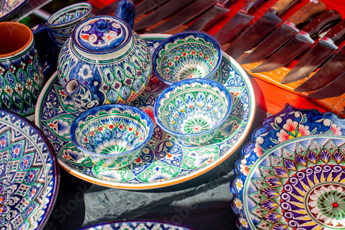 Pottery of colorful hand painted ceramic bowls and plates © Kurbanova