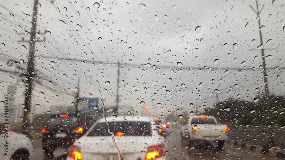Drive on the road with rain water on the windshield