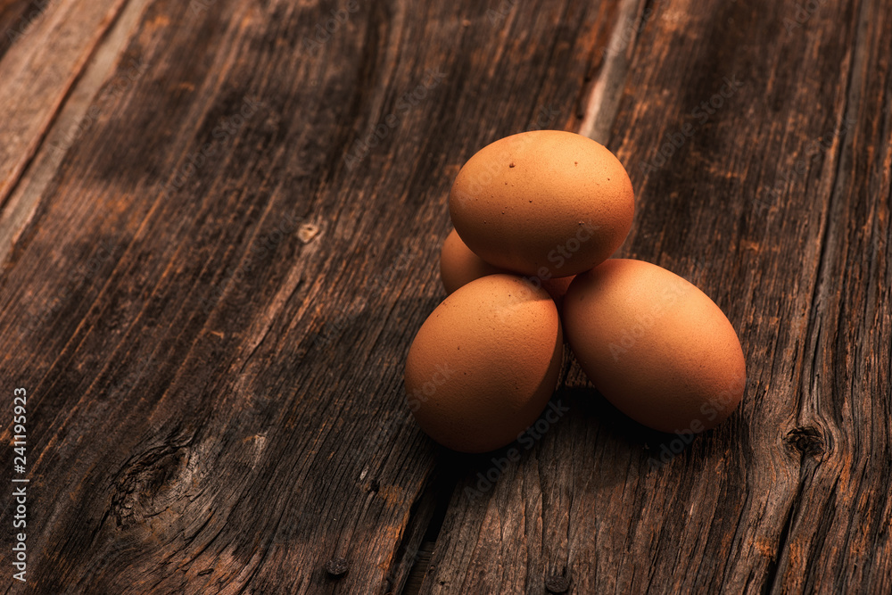 stack of eggs on wooden background horizontal with copy space stack of eggs on wooden background horizontal with copy space