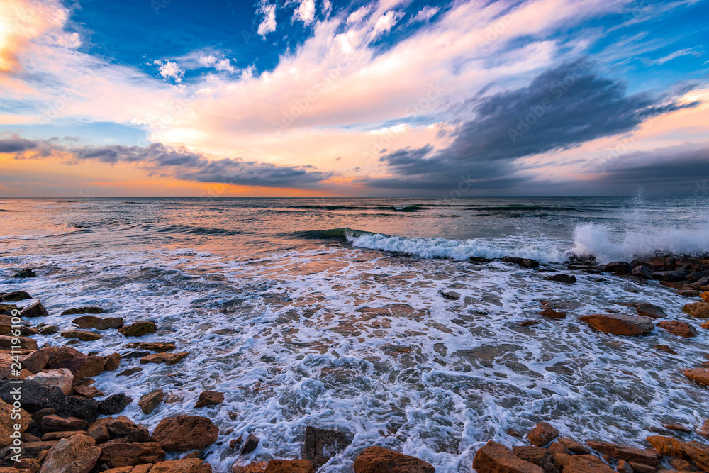 Fototapeta premium Seashore with cliffs, waves crashing on rocks
