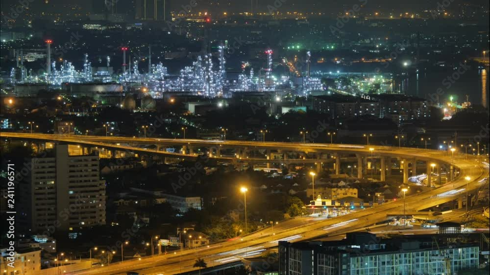 Time lapse view of Bangkok city, Thailand, showing traffic on motor way and oil refinery at night Time lapse view of Bangkok city, Thailand, showing traffic on motor way and oil refinery at night