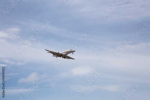 Naples, Florida, United States - November 4, 2018: Private Jet Airplane landing at an airport during a vibrant sunny day.