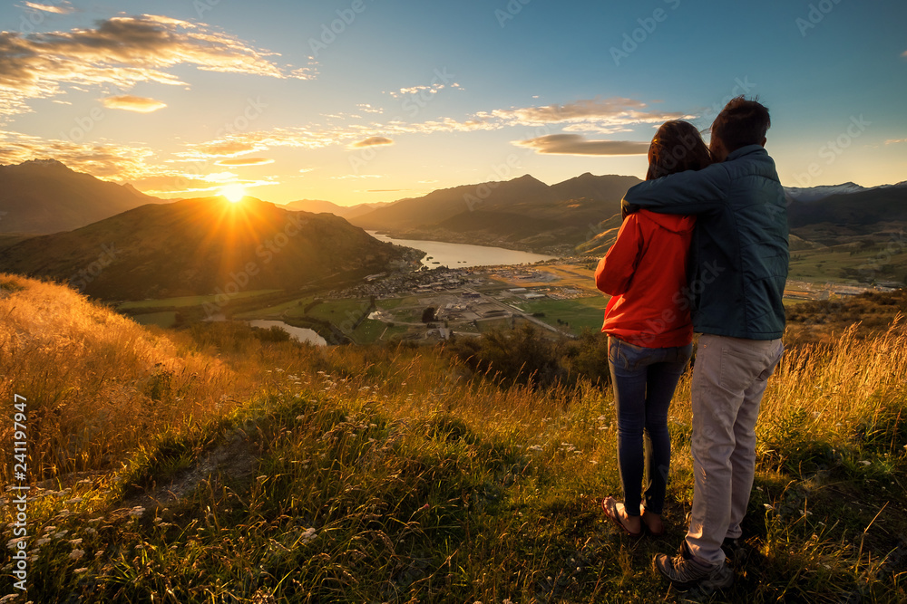 Young couple views sunset scenery on romantic travel holiday vacation valentine day