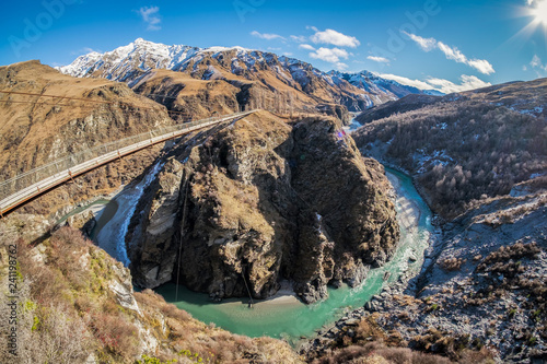 Located in New Zealand's South Island, the Skippers Canyon Road is known for its scenic roads, and scary narrow road. There are steep sheer cliff face. Below is the famous shotover river stream. photo