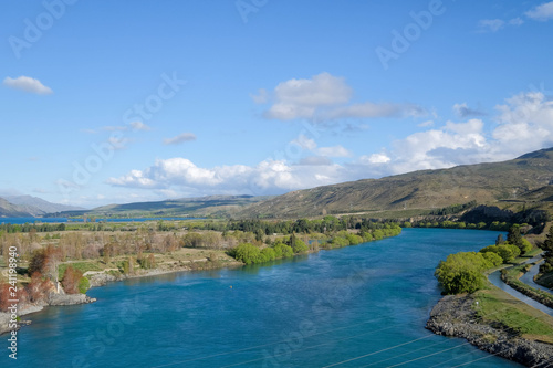 This photo is taken during road trip in New Zealand. The view is amazing. The river is extremely blue.