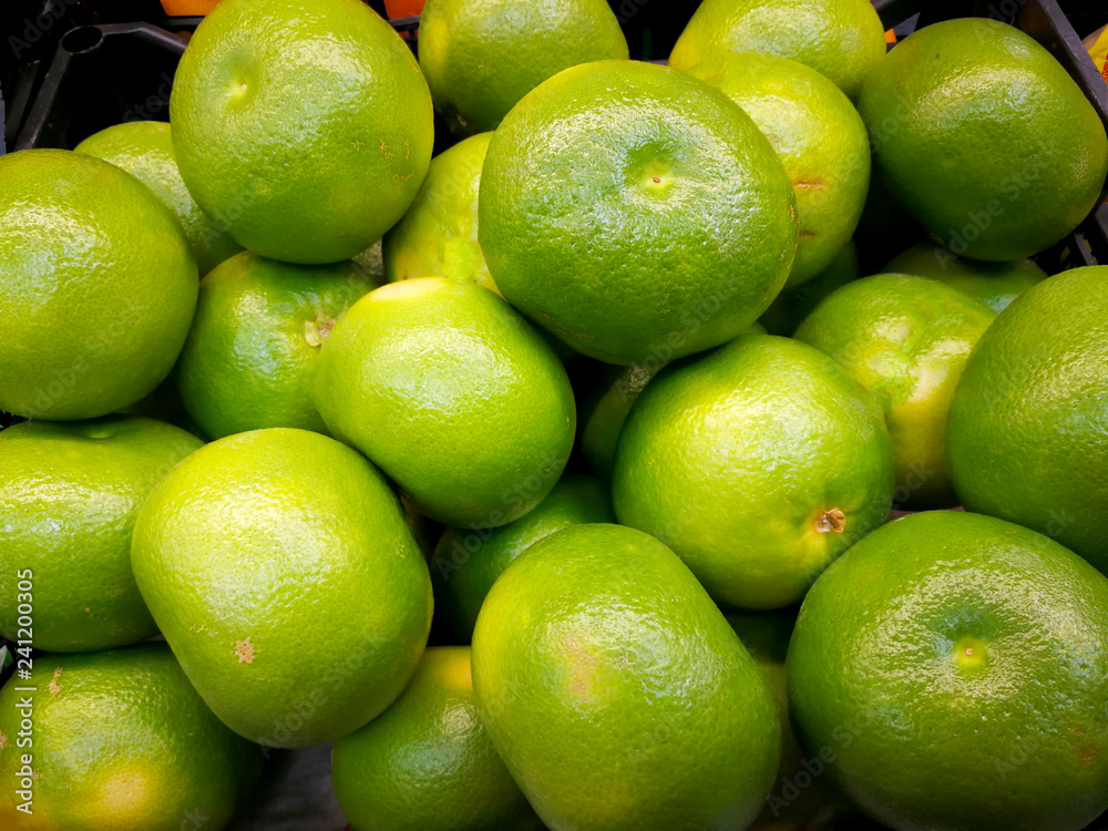 Background. Not ripe green tangerines with yellow barrels. Close-up. Background. Not ripe green tangerines with yellow barrels. Close-up.