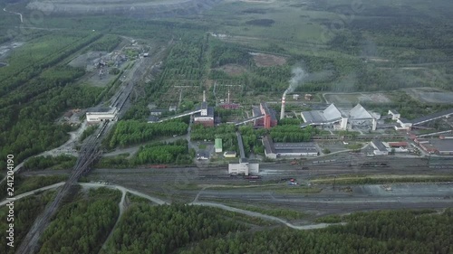 Aerial view of plant industrial area near the green forest, roads and railway. Russia. photo