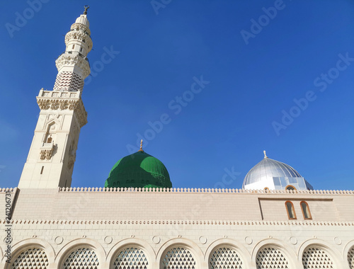 Medina, Saudi Arabia - March 25, 2018: Green dome closeup at Prophet Muhammad SAW's Mosque or Nabawi Mosque at Madinah, Saudi Arabia with selective focus and crop fragment photo