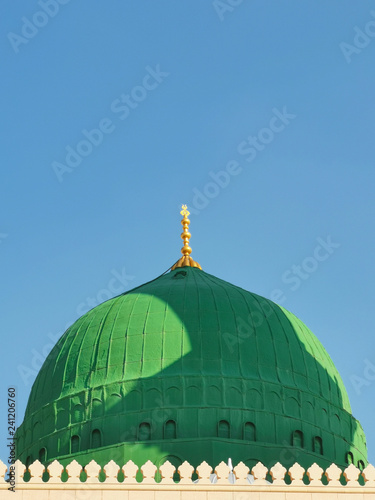 Medina, Saudi Arabia - March 25, 2018: Green dome closeup at Prophet Muhammad SAW's Mosque or Nabawi Mosque at Madinah, Saudi Arabia with selective focus and crop fragment