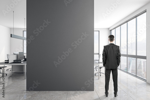 Young businessman in concrete office
