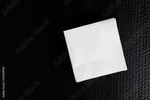 Paper napkin on black background. © Fototocam