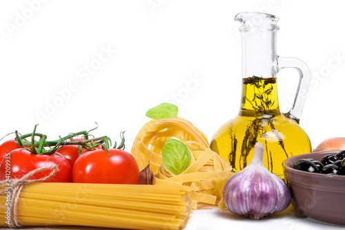 Pasta and fresh raw vegetables on white background