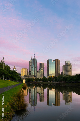 Mirror like reflections of the Melbourne CBD skyline in the Yarra River at sunrise