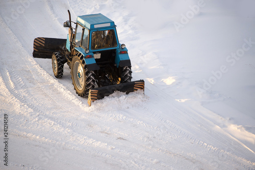 tractor cleans snow