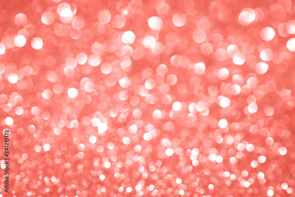 Trendy monochrome bokeh lights background in shades of coral color with copy space