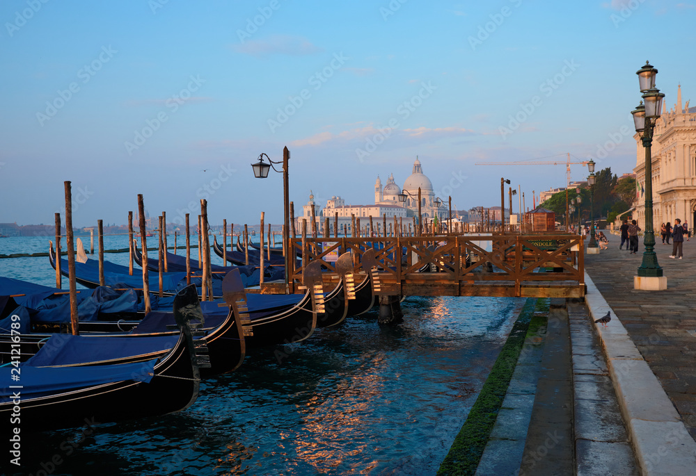 Obraz premium Venice, Italy, September 17, 2018 - Tourists walking in the early morning along the Venice Embankment