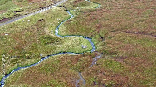Single track at Loch Cuithir and Sgurr a Mhadaidh Ruadh - Hill of the Red Fox, Isle of Skye, Scotland photo